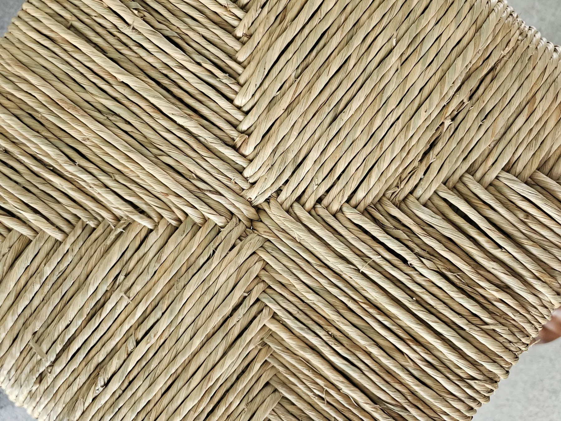 Close detail of a woven chair-seat pattern